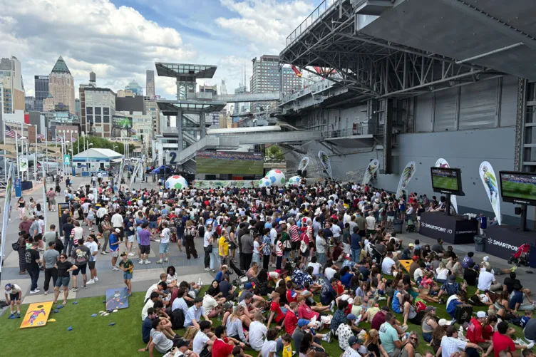 Visitors watching a soccer match on Pier 86 during an outdoor World Cup Watch Party.