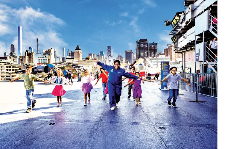 Birthday party guests enjoying an exciting experience high above the Hudson on the Intrepid Museum’s Flight Deck.