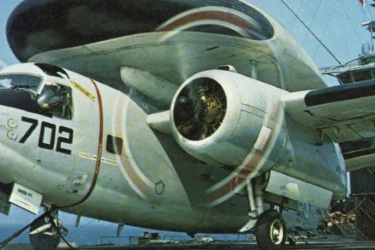 Tracer propeller plane on the flight deck of Intrepid with its wheels down and dual propellers in motion.