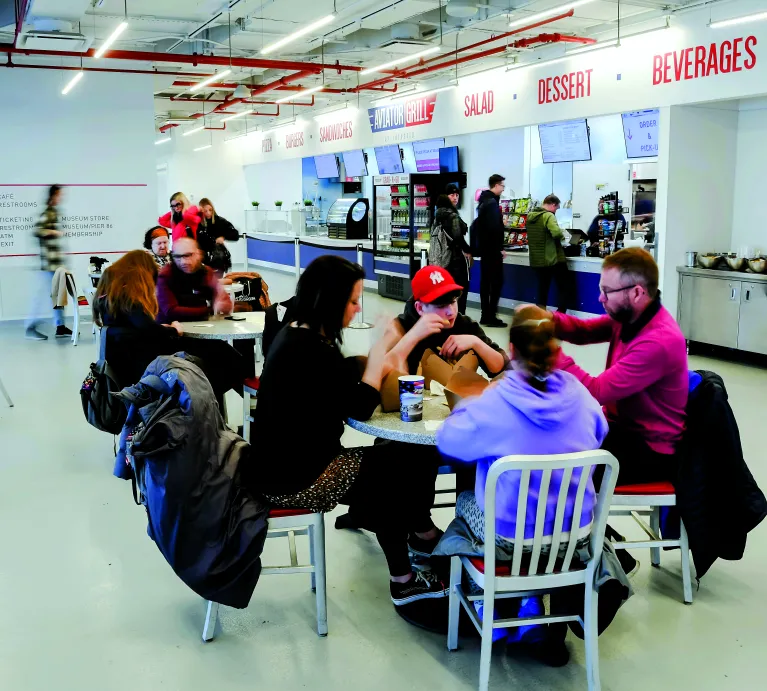 Museum visitors are eating in the Aviator Grill.