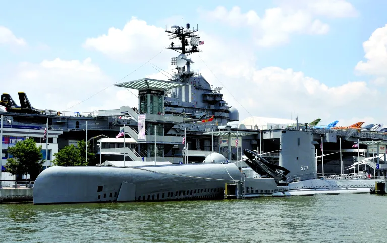 An exterior photo of the Growler with Intrepid behind it.