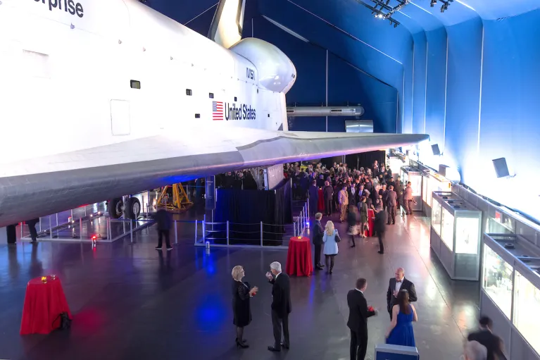 Guests mingling at an event in the Space Shuttle Pavilion