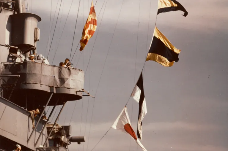 An archival photo of the Intrepid&#039;s island with flags