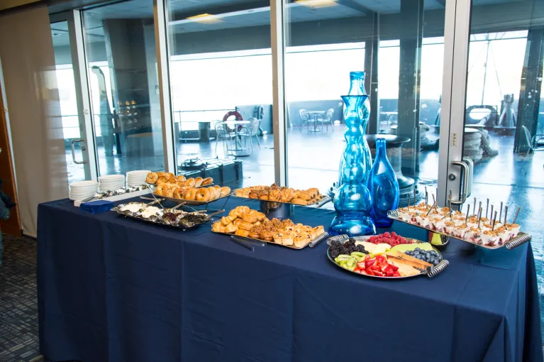 A buffet table is set up with lots of delicious treats for guests at a special event.