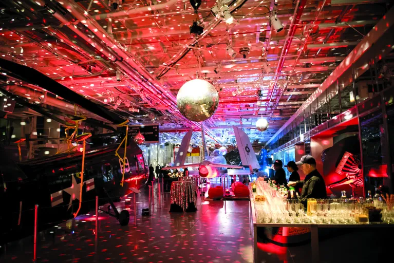 A disco ball lighting up a bar area on the hangar deck