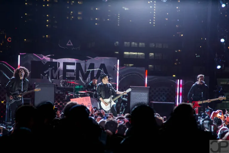 A band on a stage is playing in front of a crowd