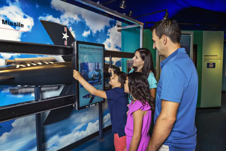 Family interacting with Growler exhibition display