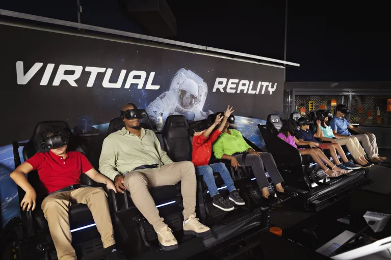 Museum visitors on the Apollo virtual reality experience wearing VR googles at the Space Shuttle Pavilion.