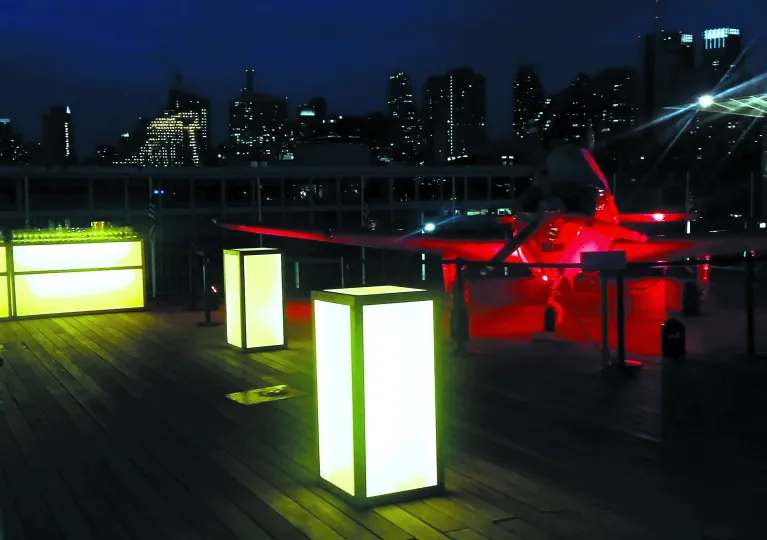 Light up bar set up with aircraft light up red in the background.