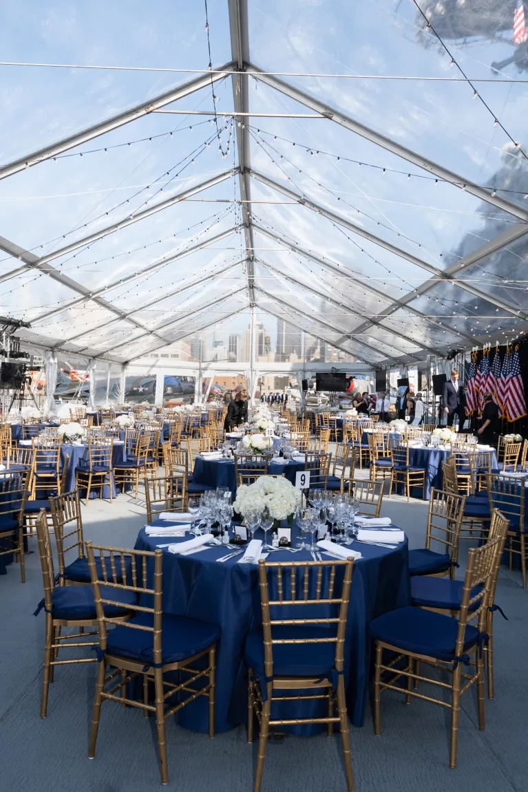 Dinner event setup with tables and chairs at the Intrepid Flight Deck 
