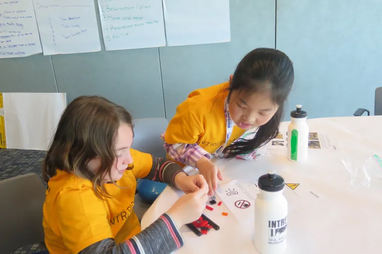 two all access campers doing an activity at the intrepid museum