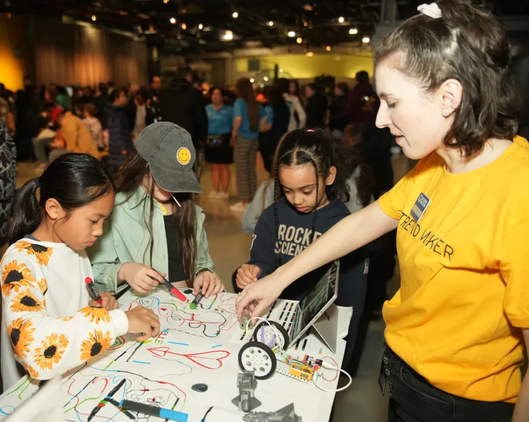 A group of young people participating in a youth program within the Exploreum interactive hall.