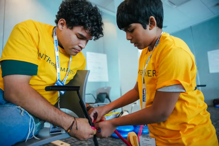 Two all access campers doing an activity at the intrepid museum