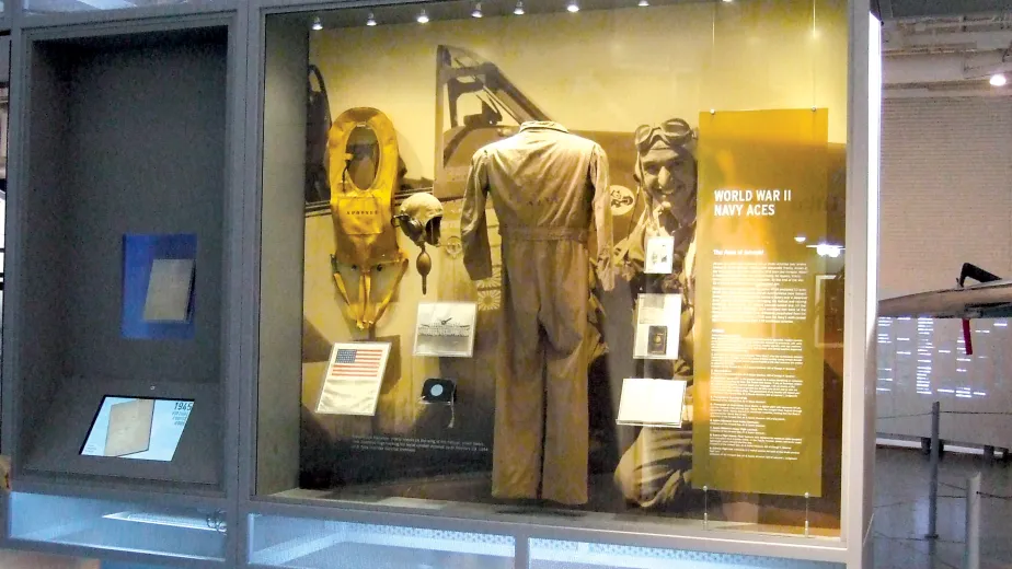 A display case showing a uniform with the headline that reads &quot;World War II Navy Aces&quot;