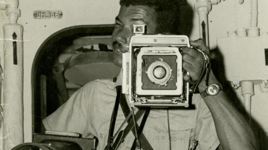 an old image of a man taking a picture using a camera