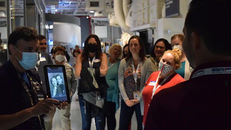 An educator teaching visitors at the USS intrepid museum about its' history