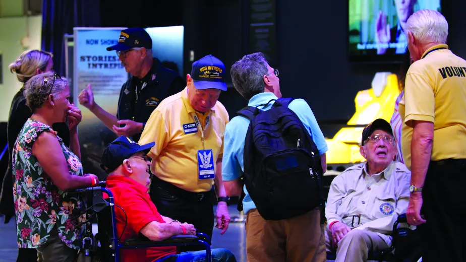 Veterans are speaking with several guests at the Museum.