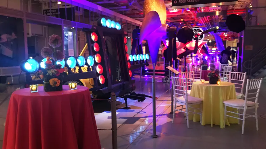 Hangar 1 set up with round tables and chairs for a reception