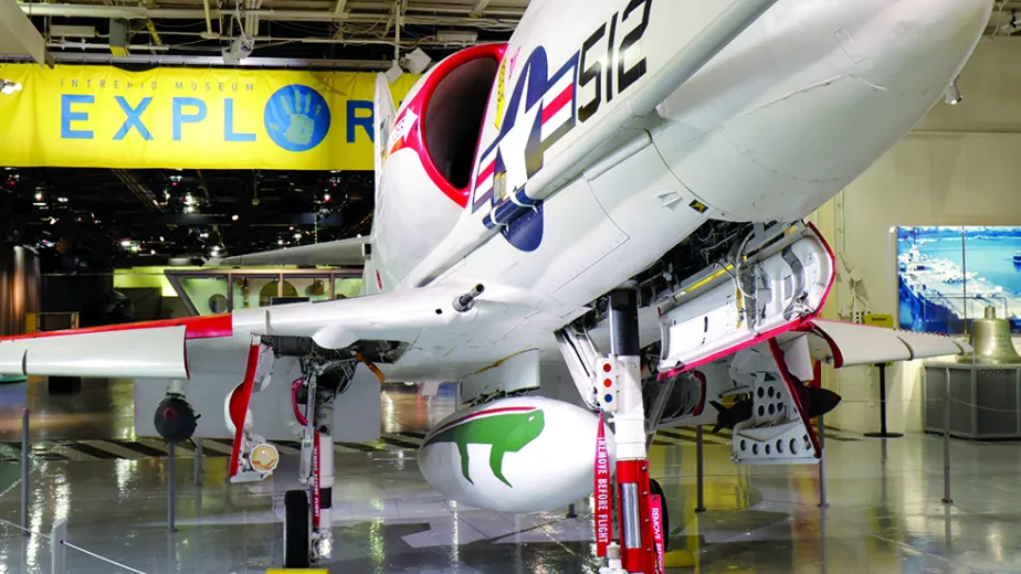 A large plane on the hangar deck with the Exploreum sign in the background.