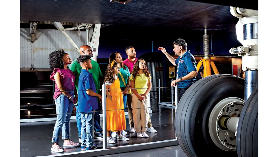 Group visiting at the Enterprise Space Shuttle with a Museum educator