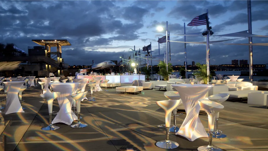 Cocktail tables and stools set up on the pier for an event
