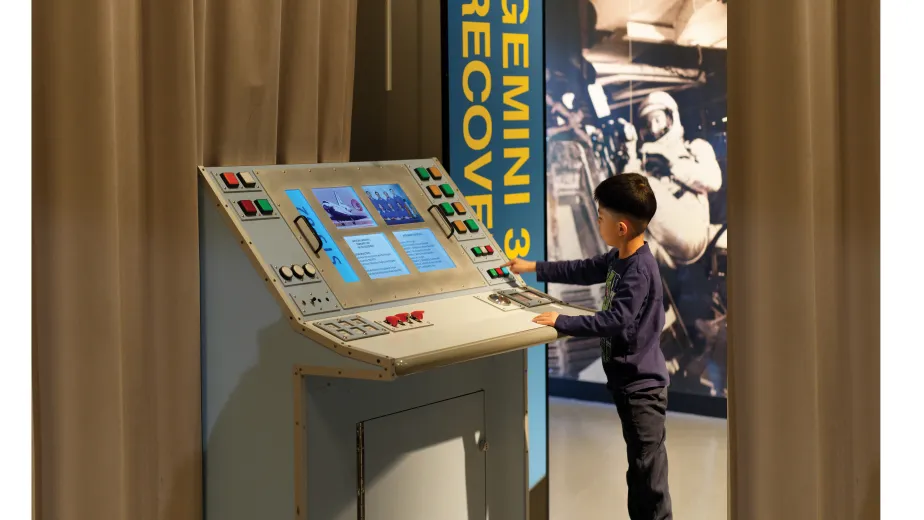 Boy interacting with an exhibition display 