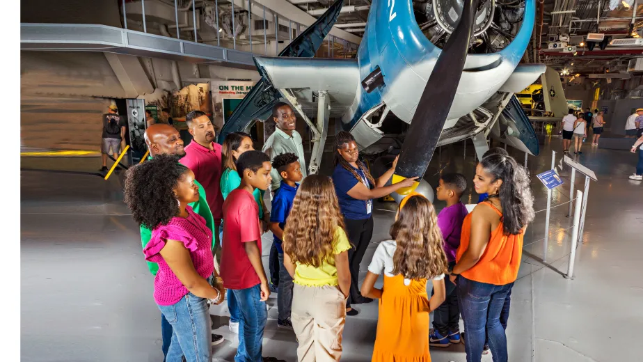 Group of visitors with a museum guide in front of the Avenger