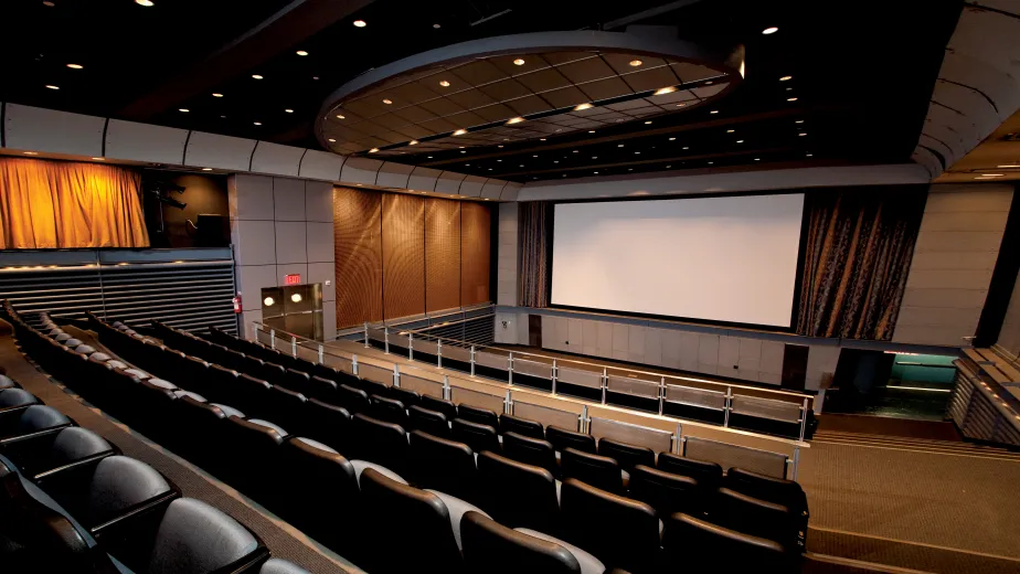 Photo of the theater with a  large screen in the background