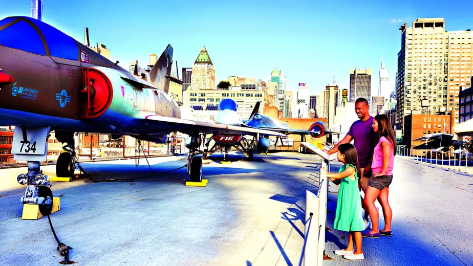 Free Fridays hero image - museum patrons on the flight deck looking at airplanes
