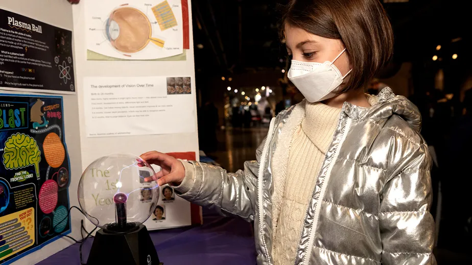 Young girl participating in a science project during Girls in Science and Engineering Day.