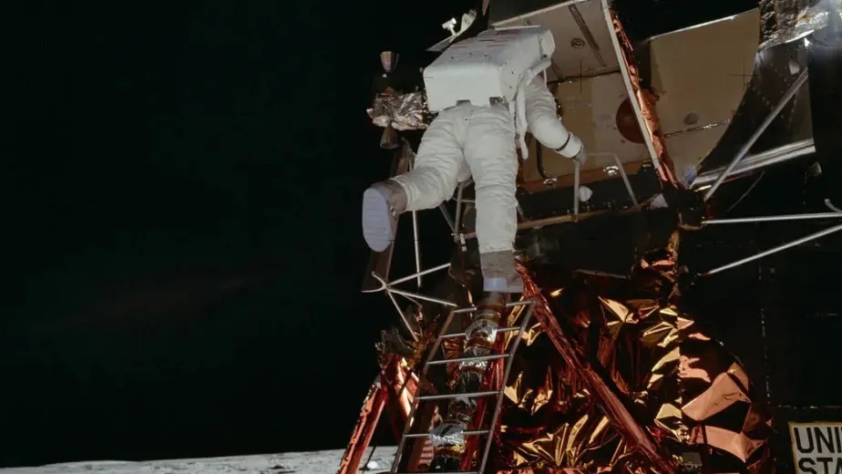 An astronaut descending the ladder of the Apollo 11 Lunar Module.