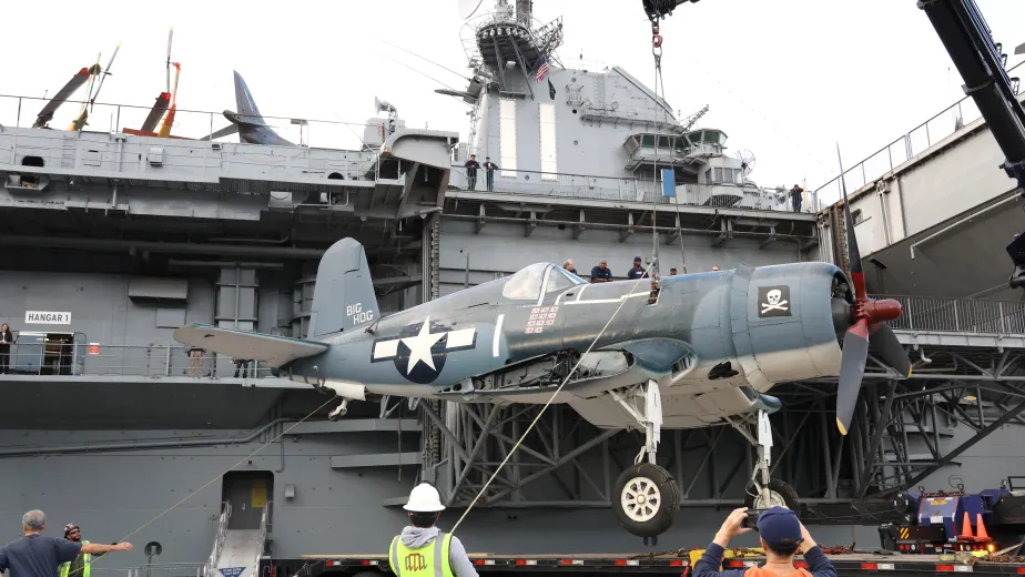 Corsair aircraft suspended on a crane at Pier 86, Intrepid Museum.