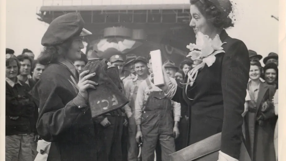 Caption: Berline Cashwell, a riveter at the Newport News shipyard, and Helen Hoover, the ship’s sponsor, at Intrepid’s christening on April 26, 1943.  Credit: Collection of the Intrepid Museum. Gift of Mrs. William H. Hoover. P2009.13.11