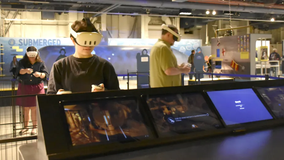 Several people enjoying Intrepid's VR experiences on board.