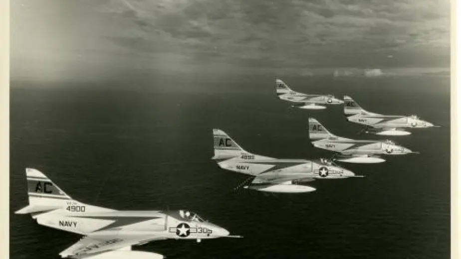 Black and white photo of five Navy jet planes flying in formation.