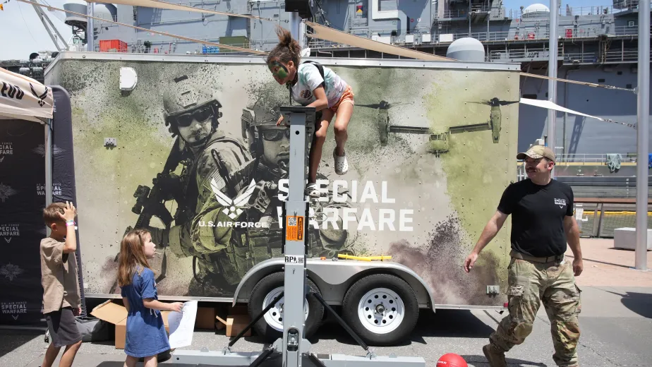 Children participating in interactive activities with the military during Fleet Week