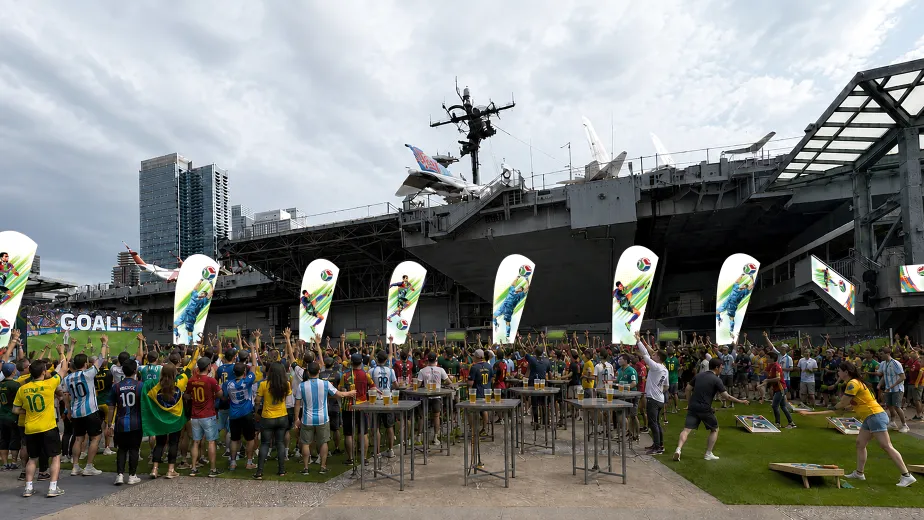Illustration of people gathered on Pier 86 cheering and watching a soccer match
