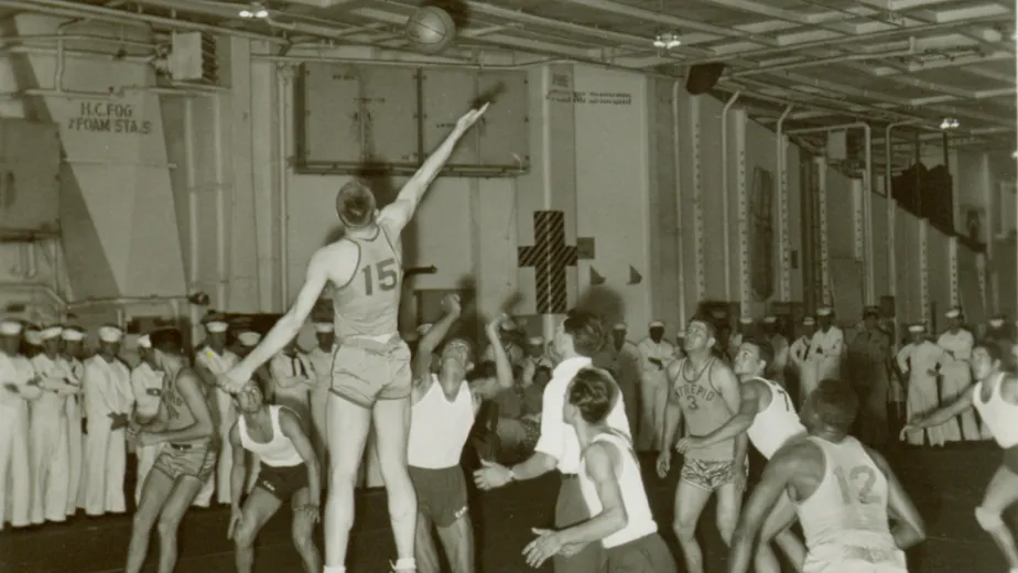 A basketball game on the hangar deck between Intrepid sailors and locals from Lisbon, Portugal, 1958.