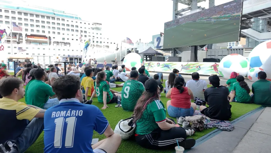 Group of people of all ages watching the world cup on pier 86