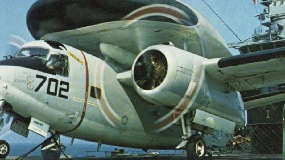 Tracer propeller plane on the flight deck of Intrepid with its wheels down and dual propellers in motion.