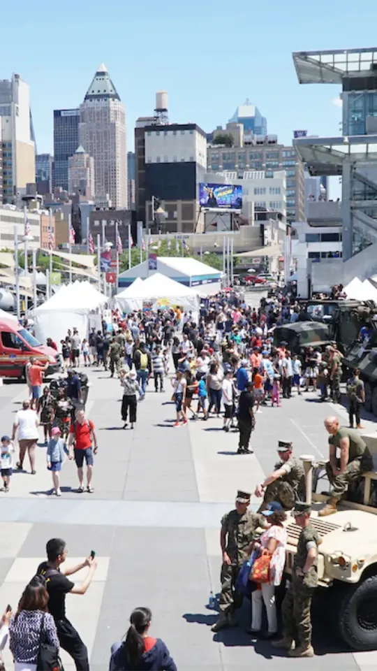 Crowds of people are on Pier 86, enjoying Fleet Week