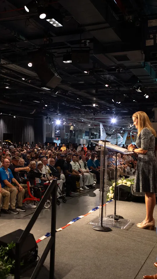 Susan Marenoff-Zausner giving a speech aboard the Intrepid during Intrepid’s Commissioning Anniversary